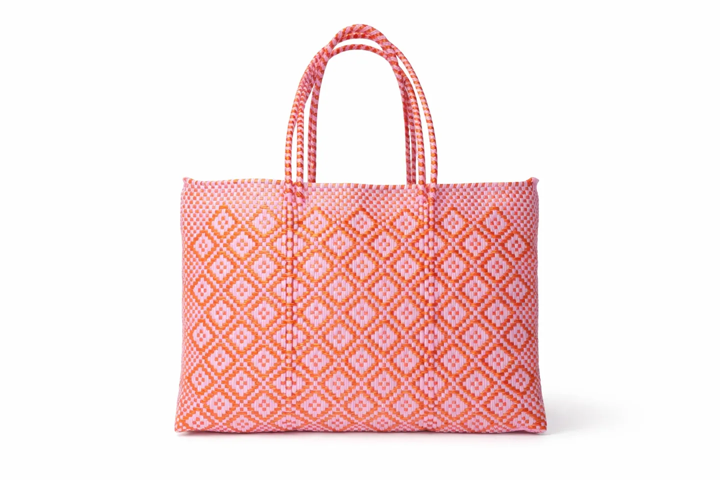 Pink and white patterned tote bag with braided handles.