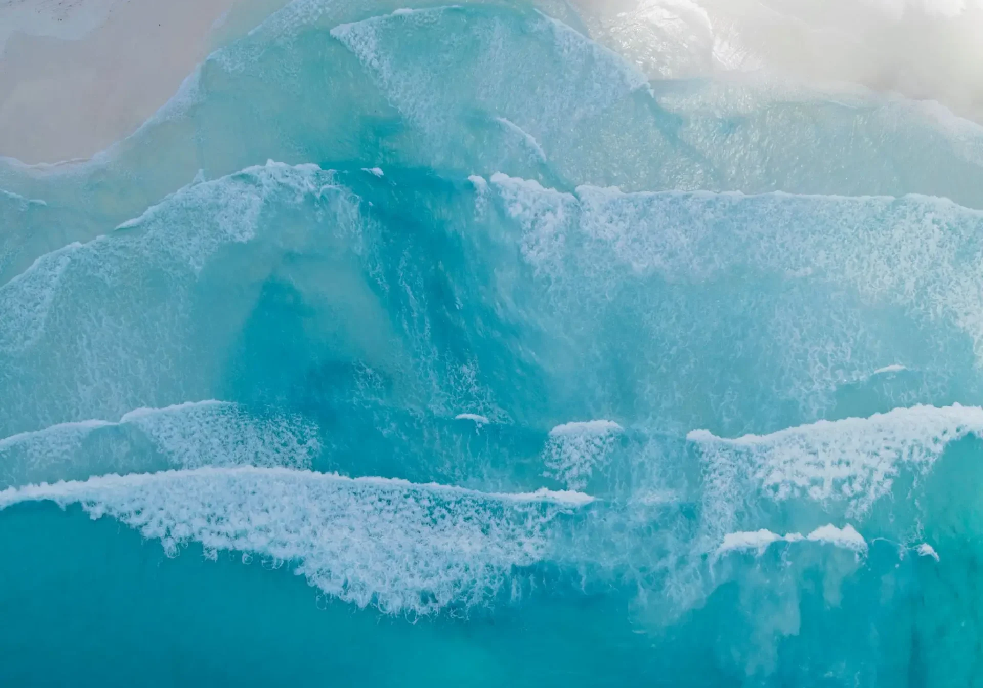 A large blue iceberg floating in the ocean.
